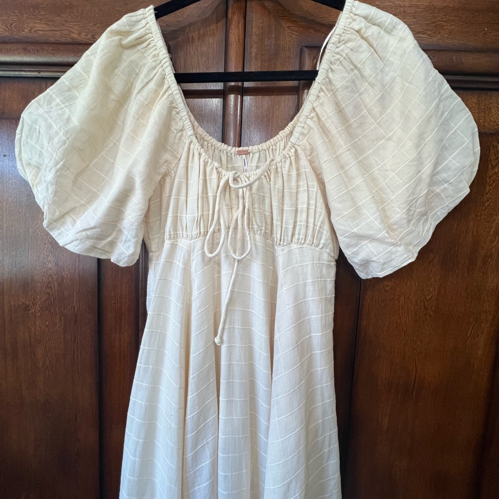 Free People dress with tie, lace and ruffled hem. NWOT